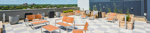A rooftop patio with tables and chairs on top of a building at Trio on Belmont in Kitchener, ON