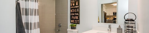 Bathroom with an oversized soaker tub, toilet and white vanity in a 1 bed 1 bath variation B in building A at Trio on Belmont in Kitchener, ON