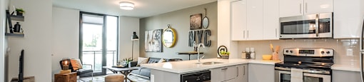 Open-concept kitchen and living area, seen from the entry, in a 1 bed 1 bath variation B in building A at Trio on Belmont in Kitchener, ON