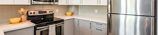 Kitchen with stainless steel appliances and white cabinets in a 1 bed 1 bath variation B in building A at Trio on Belmont in Kitchener, ON