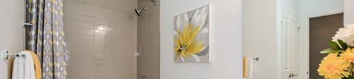 Primary bathroom with oversized soaker tub, toilet and white vanity in a 2 bed + den 2 bath variation E in building A at Trio on Belmont in Kitchener, ON