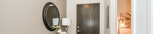 Entry area, with den to the right, in a 2 bed + den 2 bath variation E in building A at Trio on Belmont in Kitchener, ON