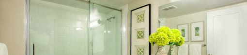 Valleyview Bathroom with glass shower doors and flourishing flower decorations in Newmarket, ON