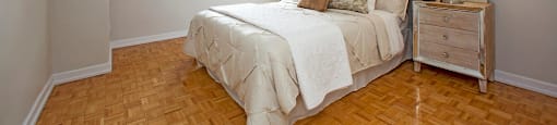 Valleyview Cozy bedroom with nightstand and long mirror on the right beside the bed in Newmarket, ON