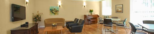 Valleyview Social room with large windows, a flat screen tv, and open space. There are several seats including a couch, plush chairs, and more in Newmarket, ON
