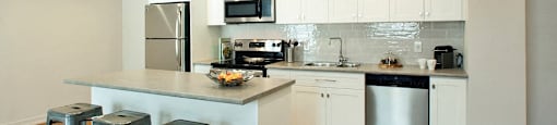 Waverly Place modern kitchen with white cabinetry and island in St. Catharines, ON