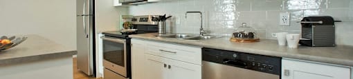 Squire Court beautiful kitchen with wite cabinetry and stainless steel appliances in St. Catharines, ON