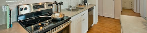 Squire Court kicthen with full range stove and over-the-range microwave in St. Catharines, ON