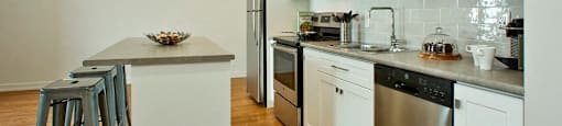 Squire Court kitchen with stainless steel appliances and island in St. Catharines, ON