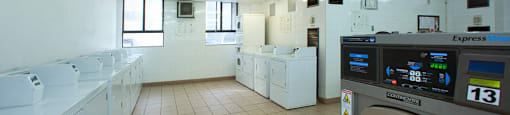 190 Cityview in Brampton, ON Shared laundry room with several washing machines and dryers