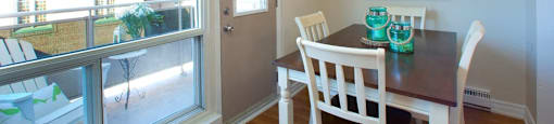 London Road Apartments dining area with view of balcony in Sarnia, ON