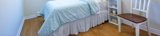 London Road Apartments large bedroom with hardwood flooring in Sarnia, ON