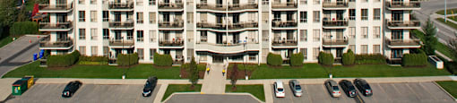 Juliana Place Apartments building exterior with parking in Woodstock, ON