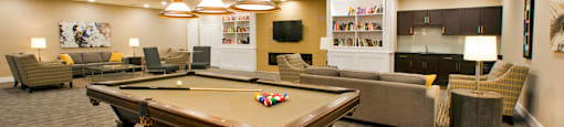 Juliana Place Apartments social room featuring lounge seating and pool table in Woodstock, ON