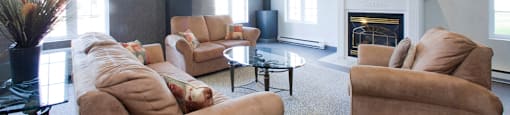 Heritage Lofts apartments lobby featuring lounge seating and fireplace in Gatineau, QC