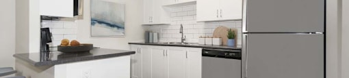 A modern kitchen with white cabinets and a grey refrigerator.