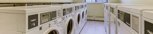 A row of washing machines in a laundromat.