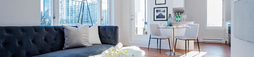 Wesley Place in Vancouver, BC Living room featuring large windows