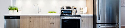 Yello On Yates modern kicthen with quartz countertops and stainless steel appliances in Victoria, BC