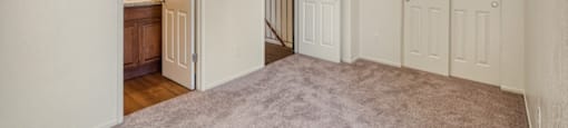 A room with white walls and a carpeted floor.