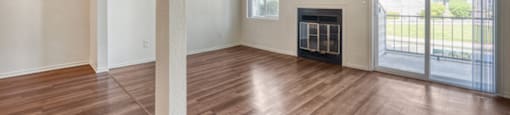 A room with wooden floors and a fireplace.