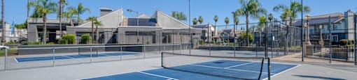 A tennis court with a net and two flags on top of a building.