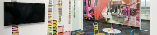 Playroom with bright colored carpet square carpeting at Parc West Apartments, Draper, Utah