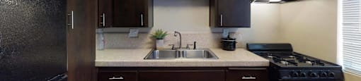 a kitchen with a sink and a stove at The Marquee Apartments, North Hollywood, California