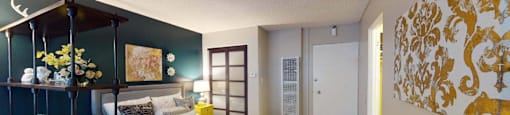 a bedroom with a bed and a painting on the wall at The Marquee Apartments, California 91605