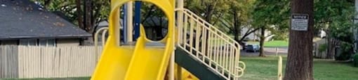 a yellow slide on a playground in a park at Ridgecrest Timbers Apartments, Portland, Oregon