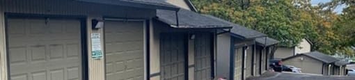 a row of garage doors on the side of a building at Ridgecrest Timbers Apartments, Portland, 97203