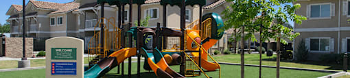 A playground with a slide and a sign that says "Welcome".