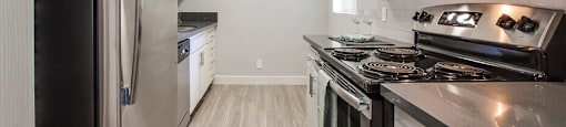 A modern kitchen with stainless steel appliances and white cabinets.