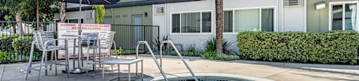 A hot tub sits in the middle of a concrete patio at The Marquee Apartments, California 91605