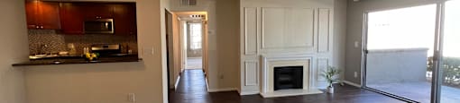 A spacious living room with a fireplace and sliding glass doors.