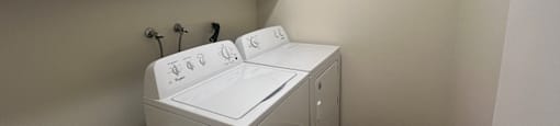 A white washing machine in a small laundry room.