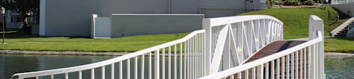 A white building with a white railing and a white staircase.