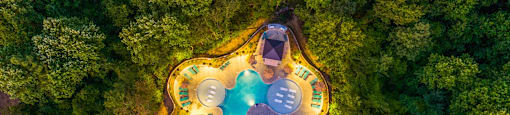 a birdseye view of a house with a pool and trees