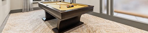 Langley Pointe Apartments | Billiards Room w/ View of the Pool