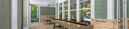 Langley Pointe Apartments | Screened in Patio w/ Shuffleboard