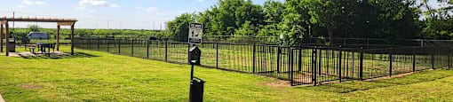 Sign is on a post in a grassy field.