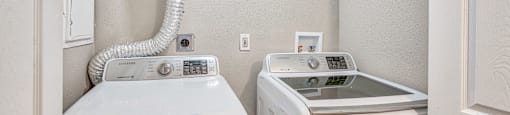 A washer and dryer in a small laundry room.