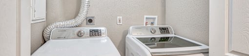 A washer and dryer in a small laundry room.