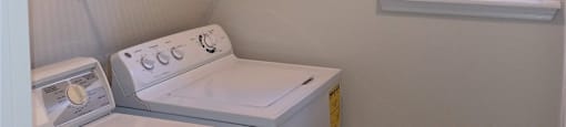 A small laundry room with a washer and dryer.