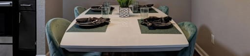 A dining room with a table set for two.