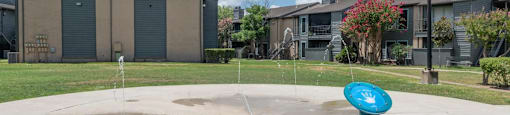 A playground with a blue sign on a pole.