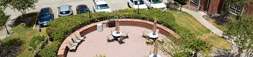 A large brick building with a circular patio in front.