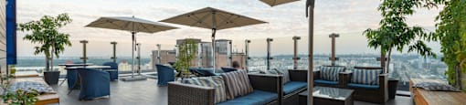 A patio with a table and chairs under a large umbrella.