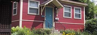 A red house with a blue door and windows.