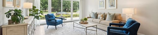 spacious living room with blue chairs and a couch